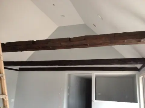 Empty loft space with exposed timber beams