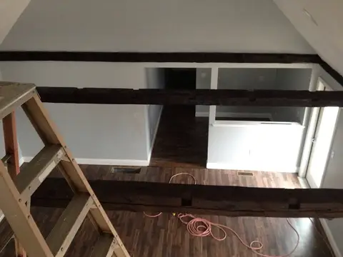 Upper level with ladder and beams, before the salon