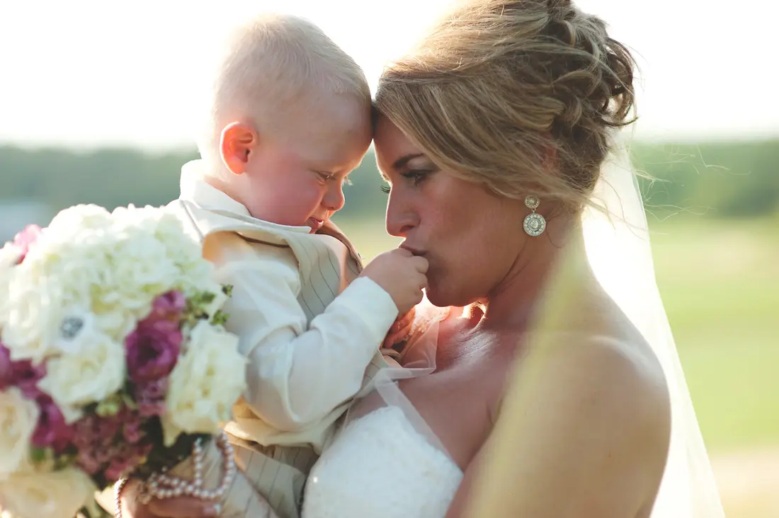 A bride holding her baby, styled by Razoux & Co