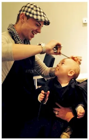 Stylist giving a child a haircut