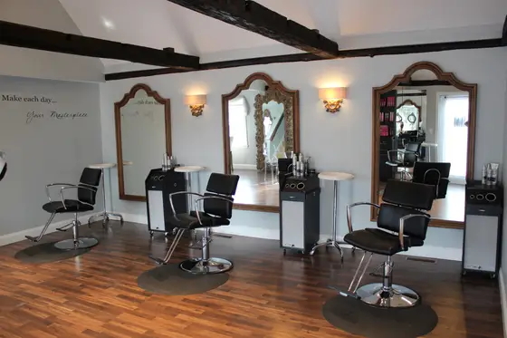 Salon interior with exposed beams and styling chairs