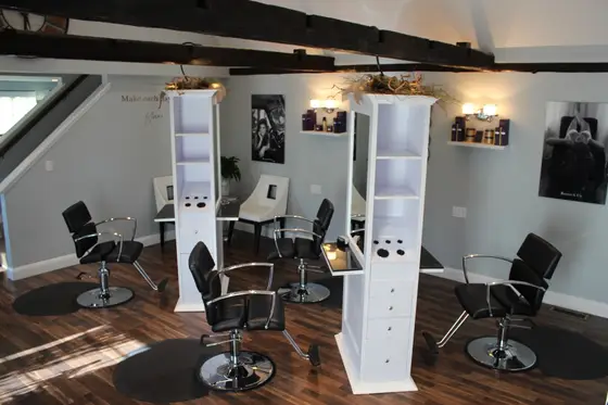 Salon floor with styling stations and wood floors