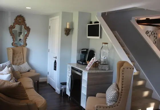 Waiting area with gold mirror and armchair