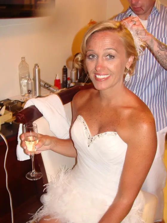 Bride getting ready with a glass of champagne