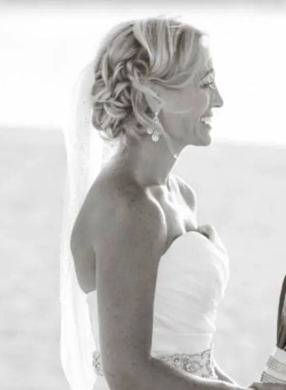 Black and white profile of a bride with a soft updo