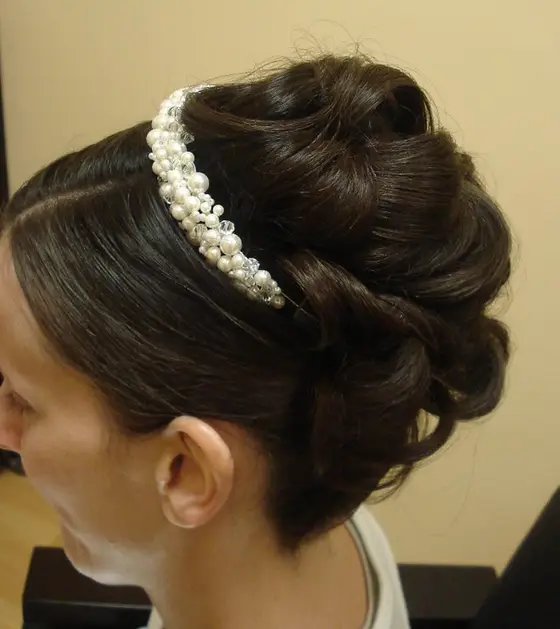 Profile of an updo with a pearl headband